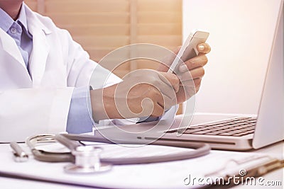 Woman doctor using mobile smart phone . Stock Photo
