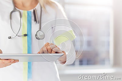 Woman doctor using tablet computer in hospital Stock Photo