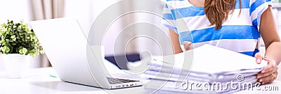 Woman with documents sitting on the desk Stock Photo