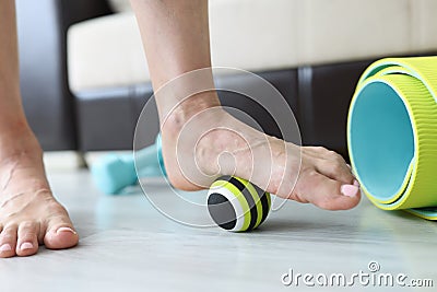 Woman does exercises with ball to correct foot defects and flat feet Stock Photo