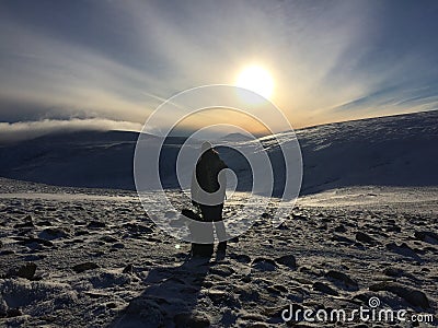 Woman and dog hiking in the mountains Stock Photo