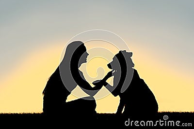 Woman and Dog Shaking Hands Sunset Silhouette Stock Photo