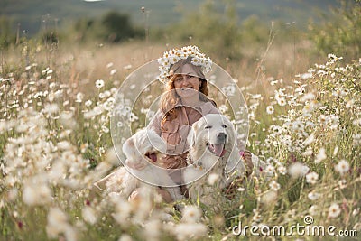 Woman dogs meadow chamomile. Woman embraces her furry friends in a serene chamomile field, surrounded by lush greenery Stock Photo