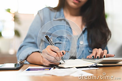 Woman doing accounting home finance expenses and calculate credit card monthly debt to bills payment Stock Photo