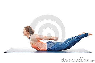 Woman doing Ashtanga Vinyasa Yoga asana Salabhasana Stock Photo