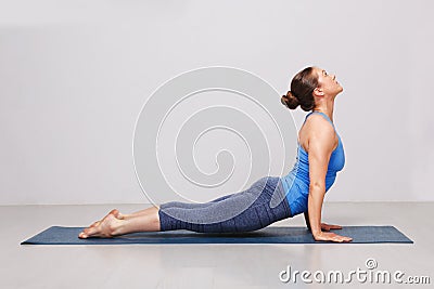 Woman doing Ashtanga Vinyasa yoga asana Urdhva mukha svanasana Stock Photo