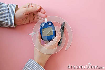 Woman doing blood glucose measurement using glucometer. Gestational diabetes mellitus concept. Stock Photo