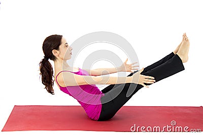 Woman doing a boat pose variation in yoga Stock Photo
