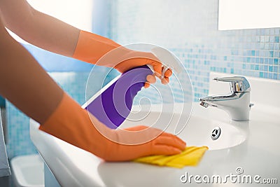 Woman doing chores cleaning bathroom at home Stock Photo