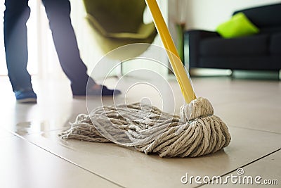 Woman Doing Chores Cleaning Floor At Home Focus on Mop Stock Photo