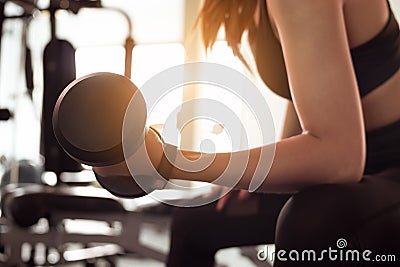 Woman doing exercise workout dumbbell at fitness gym. lifestyle and exercise concept Stock Photo