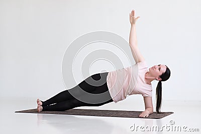 Woman doing exercises, Side Plank Pose, Vasisthasana, Yoga Pose Stock Photo