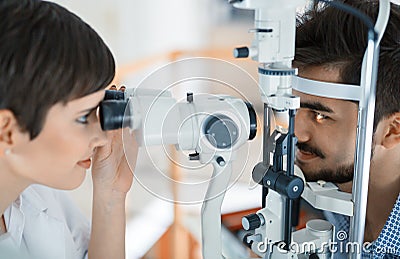 Woman doing eye test with optometrist in eye sight clinic Stock Photo