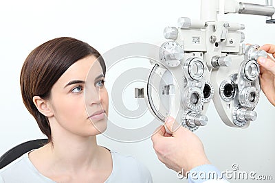 Woman doing eyesight measurement with optical slit lamp Stock Photo