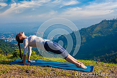 Woman doing Hatha yoga asana Purvottanasana Stock Photo