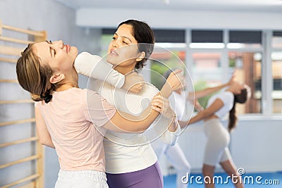 Woman doing a head kick during self defense training Stock Photo