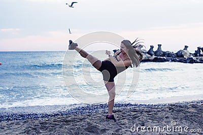 Woman doing martial arts at the beach Stock Photo