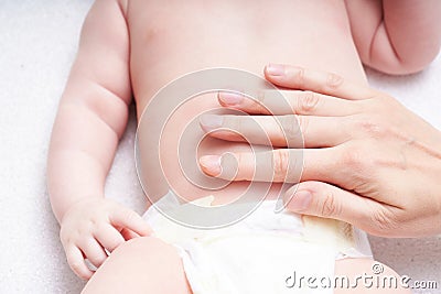 Woman doing massage against colic tummy to baby Stock Photo