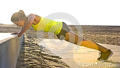 Woman doing Press ups on a beach Stock Photo