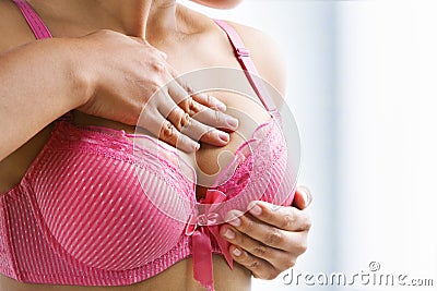 Woman doing self breast examination Stock Photo