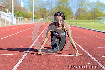 Woman doing sprint training on a sports track Stock Photo