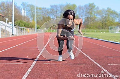 Woman doing sprint training on a sports track Stock Photo