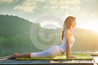 Woman doing yoga on the lake Stock Photo