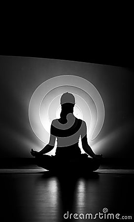 Woman doing yoga meditation silhouette black and white Stock Photo