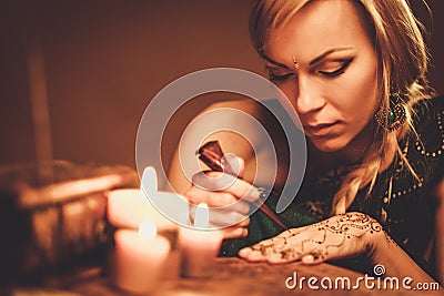 Woman drawing henna menhdi ornament Stock Photo