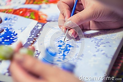 Woman is drawing the paint by numbers Stock Photo