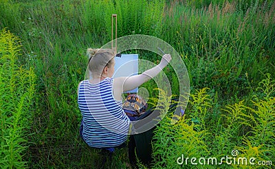 Woman drawing painting in nature Stock Photo