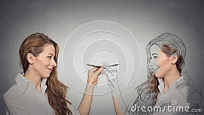 Woman drawing a picture, sketch of herself Stock Photo