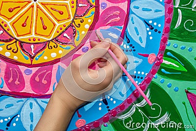 Woman draws a mandala, hand with a brush close-up Stock Photo