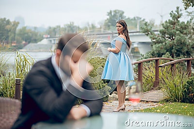Woman in dress standing at distance and unhappy man Stock Photo