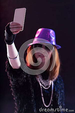 Woman dressed as a popstar taking a selfie Stock Photo