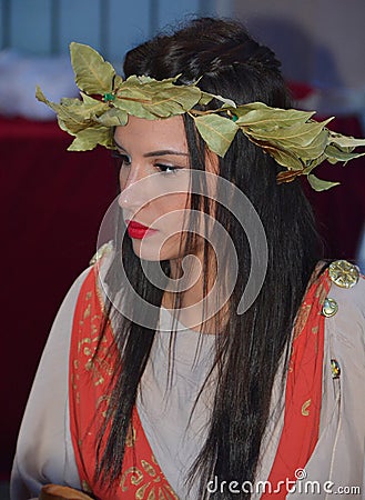 Woman dressed as Roman priestess for tourists in the Old Town of Pula Editorial Stock Photo