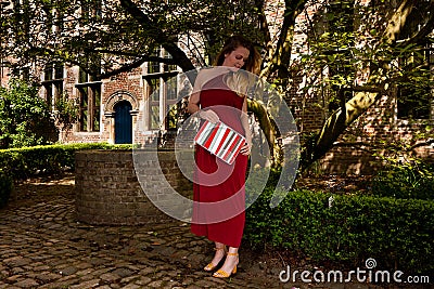 Woman red antique dress, Groot Begijnhof, Leuven, Belgium Stock Photo