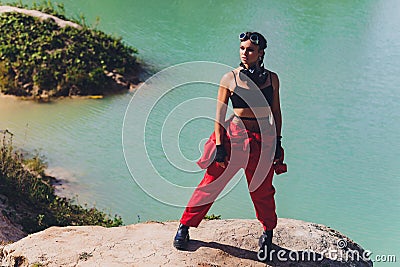 Woman dressed in a steampunk suit in a defiant attitude with her arms crossed. Stock Photo