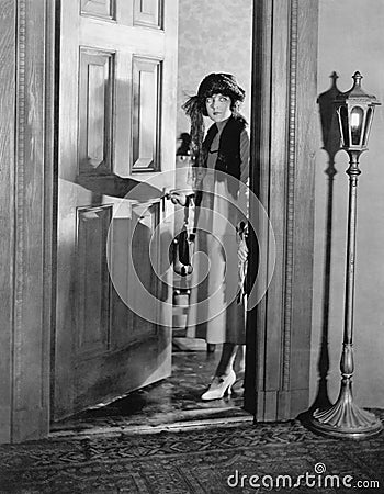 Woman dressed up standing in the doorway Stock Photo