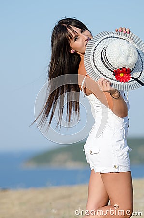 Woman dressed with white coveralls rompers joying the sunny day Stock Photo