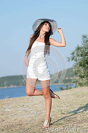Woman dressed with white coveralls rompers joying the sunny day Stock Photo