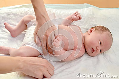 The woman dresses to the baby a diaper Stock Photo