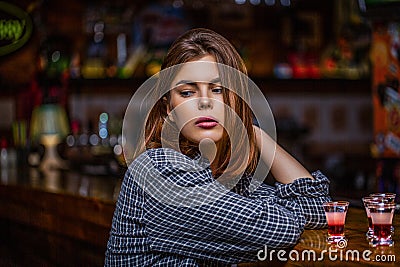 Woman drinking alcohol. Scotch whiskey glass isolated at bar or pub in alcohol abuse and alcoholic concept. Drunk woman Stock Photo