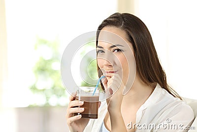 Woman drinking cocoa shake with a straw Stock Photo
