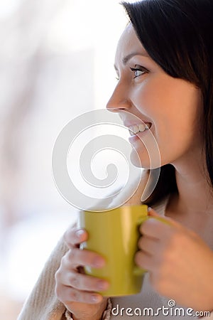 Woman drinking coffee. Beautiful middle-aged woman standing in f Stock Photo