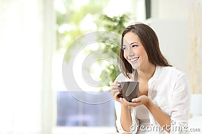 Woman drinking coffee or tea at home Stock Photo