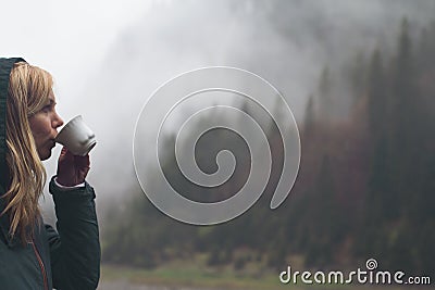 Woman drinking a cup of coffee in outdoor setting Stock Photo