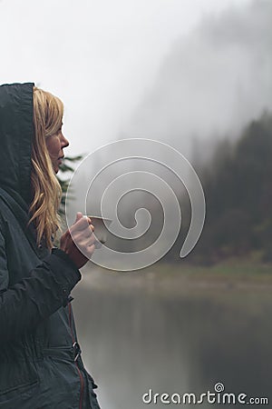 Woman drinking a cup of coffee in outdoor setting Stock Photo