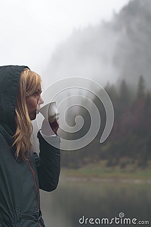 Woman drinking a cup of coffee in outdoor setting Stock Photo