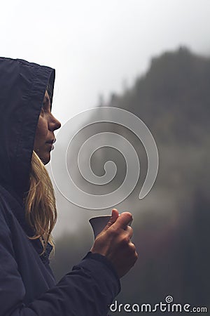 Woman drinking a cup of coffee in outdoor setting Stock Photo